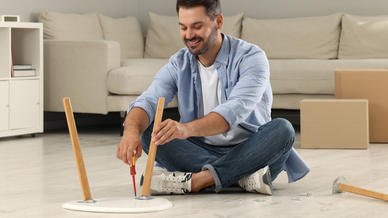 Man assembling stool