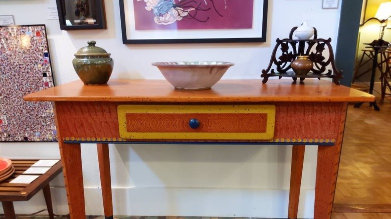 A bright orange David Marsh table in a furniture store