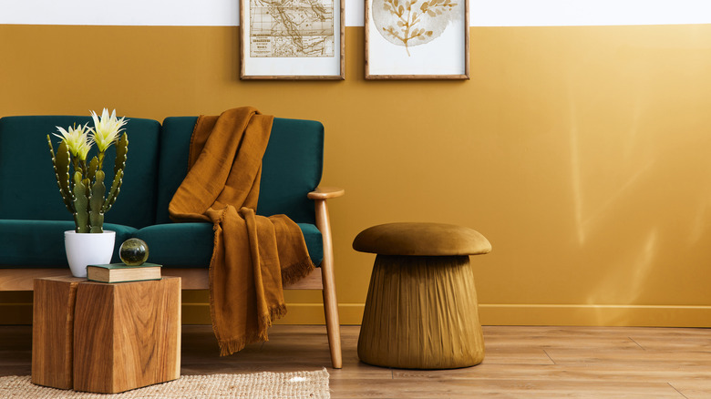 gold walls with green sofa