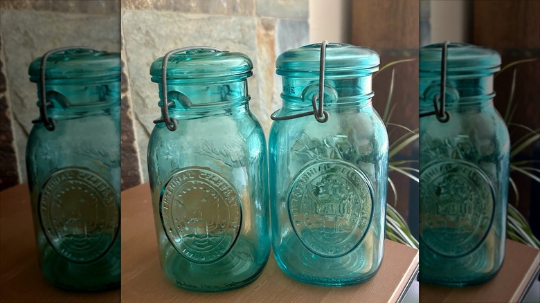 Two of the Bicentennial Ball Mason jars in blue glass
