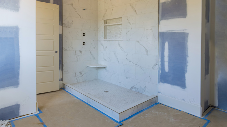 A bathroom remodel with a partially finished shower.