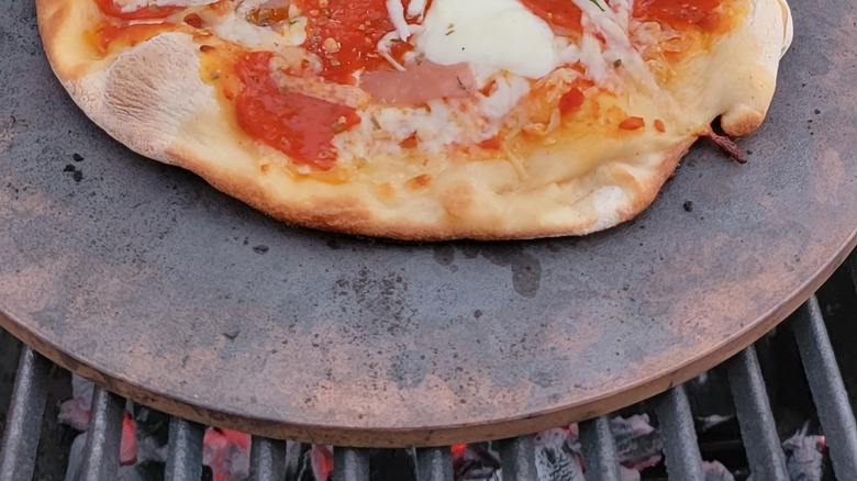 Pizza cooking on stone