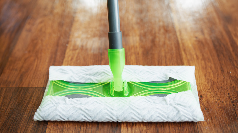 Swiffer mop head resting on a wood floor.