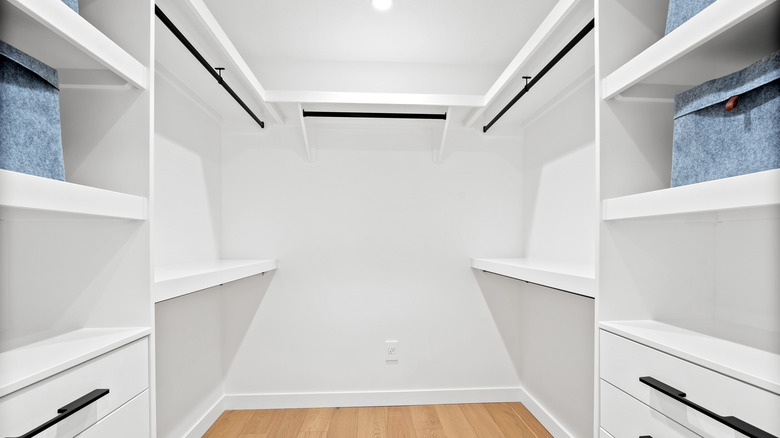 Large empty white closet with shelves and separators