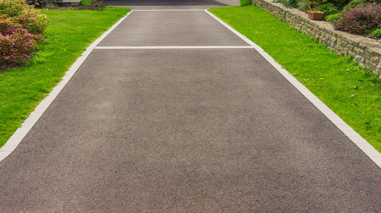 A new asphalt driveway with attractive and durable concrete edging