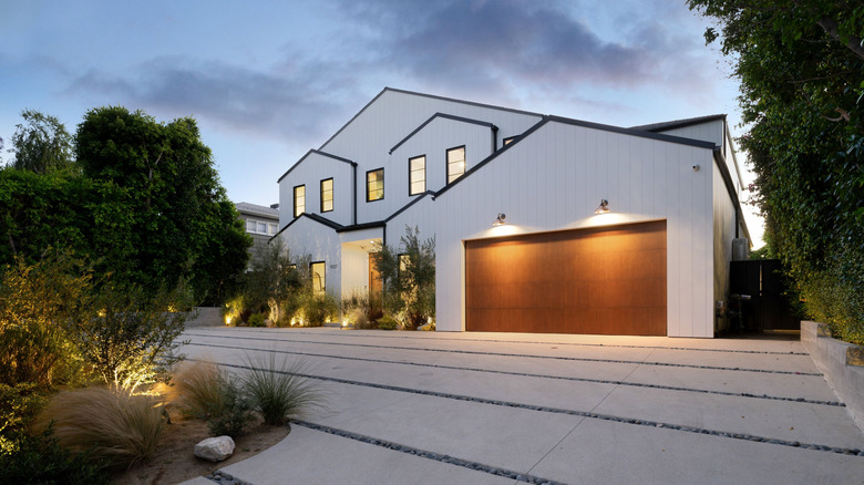 Modern home at dusk with exterior and landscape lighting