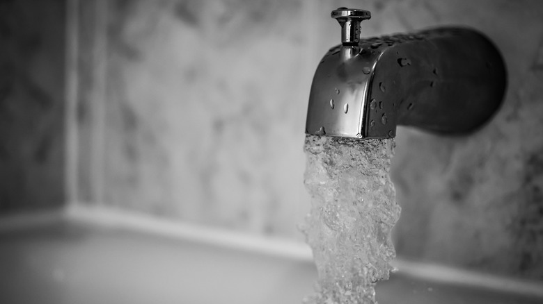 Bath faucet pouring water