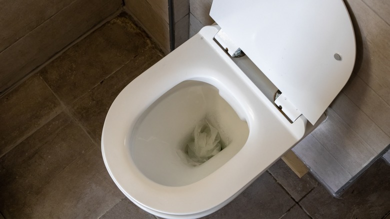 White porcelain clogged toilet