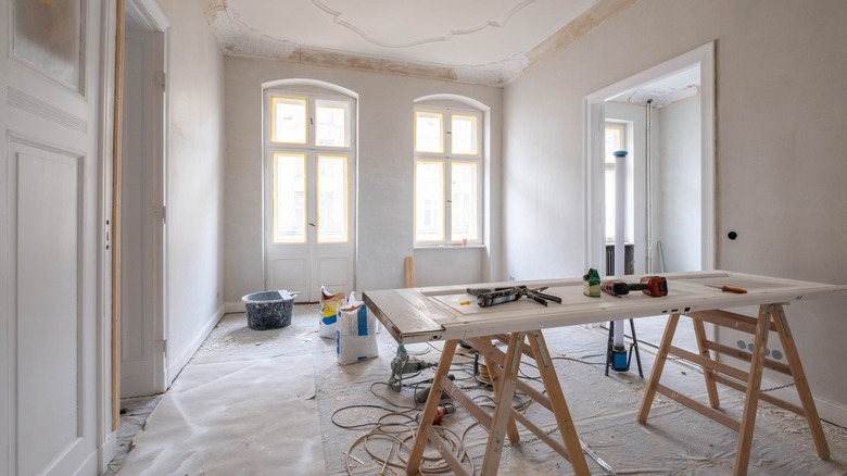 A room under renovation with tools and supplies
