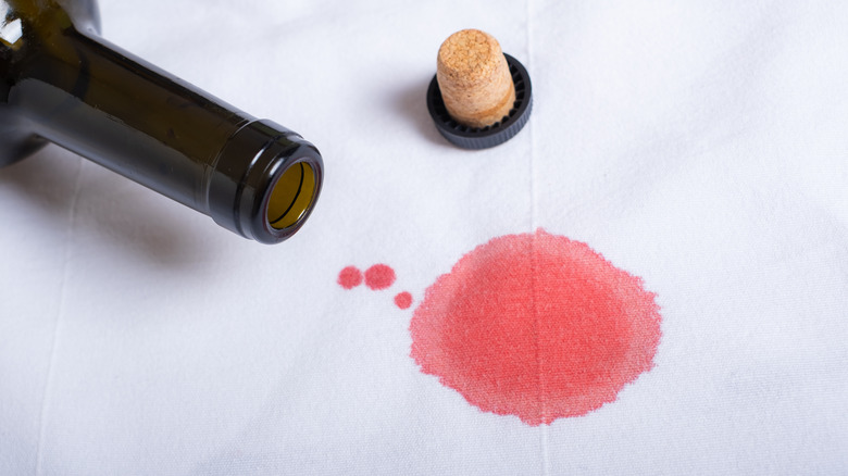 wine bottle spilled on tablecloth