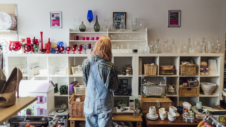 A woman shopping in the home section at a thrift store