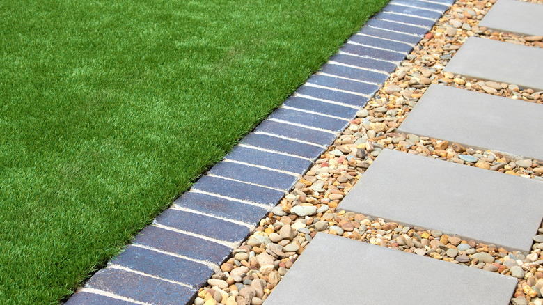 Close up of modern garden pathway with gravel and grass