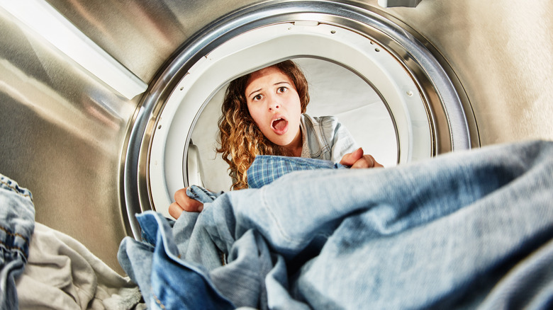 lady looking into dryer shocked