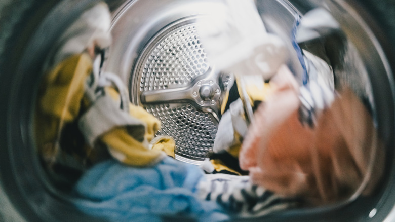 View from inside a washing machine as clothes spin around inside