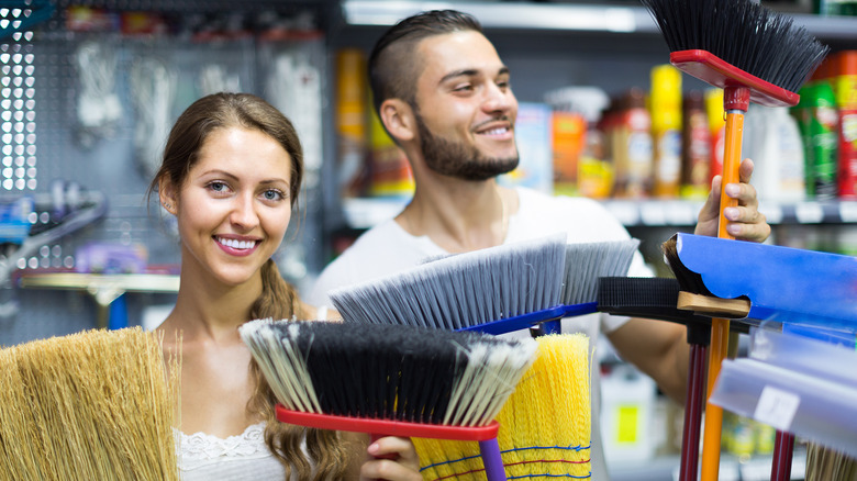 couple shopping for new broom