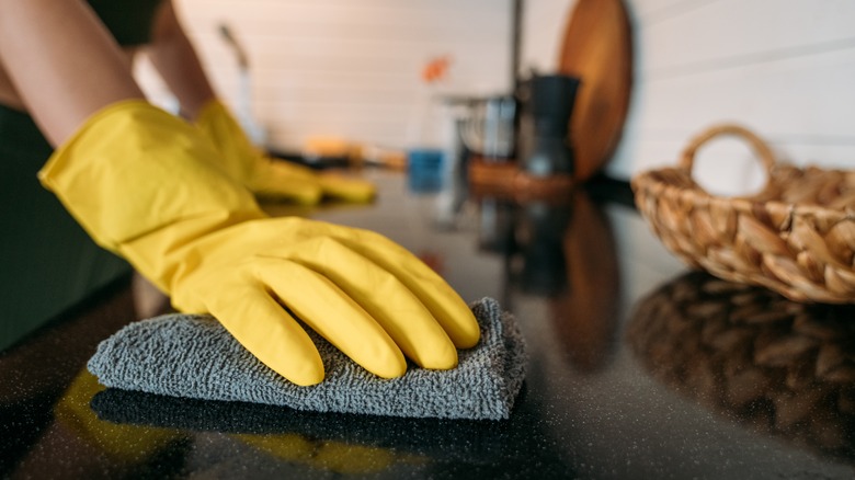 Person wiping countertop