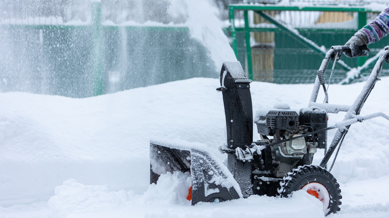snow blowing during winter storm