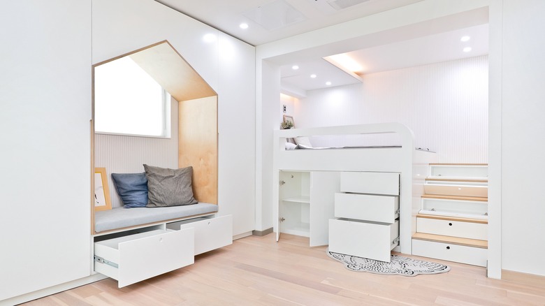 Hidden storage drawers and cabinets in a white bedroom