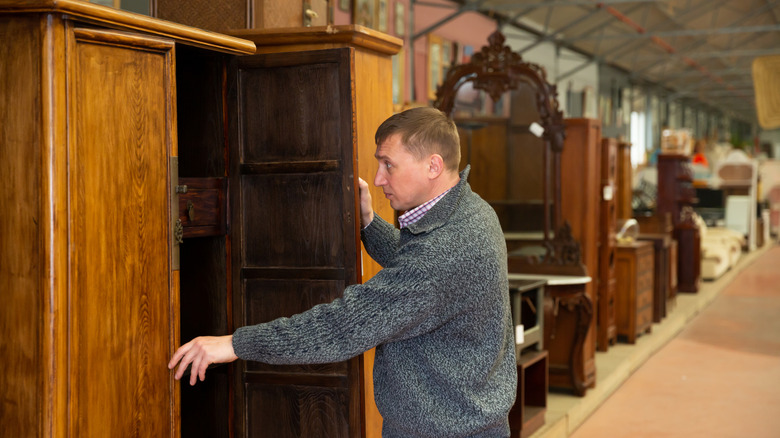 man shopping for wooden furniture