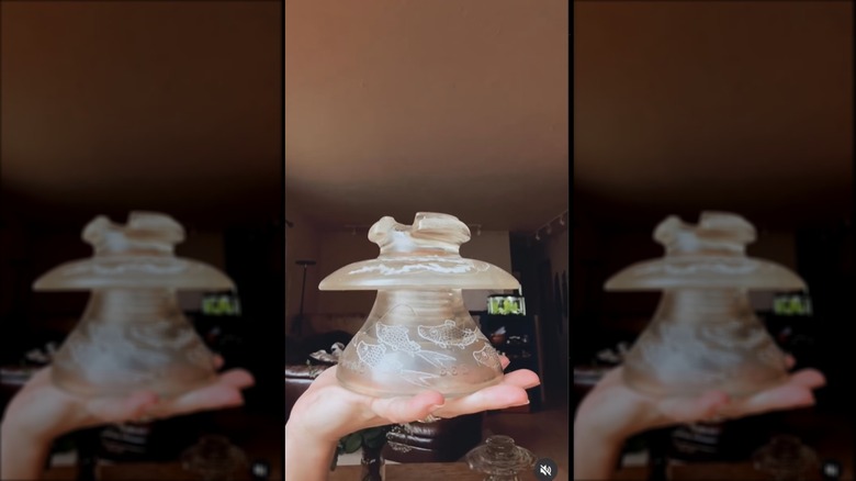 Etched glass insulator in hand