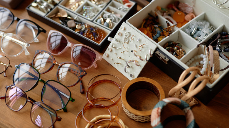 A collection of glasses, jewelry, and trinkets.