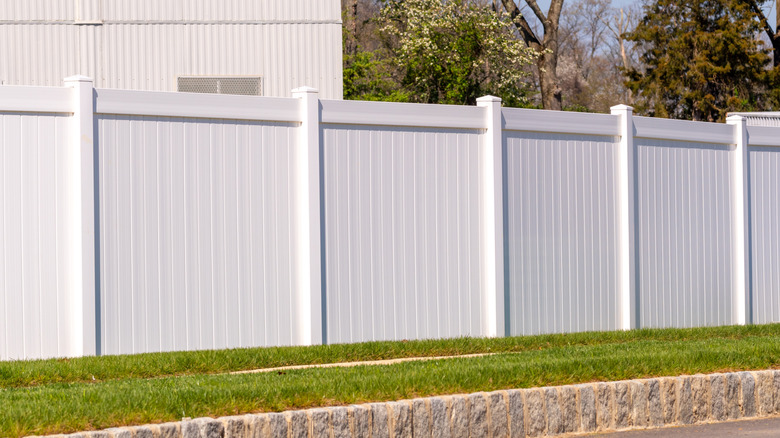 White vinyl fence with green grass