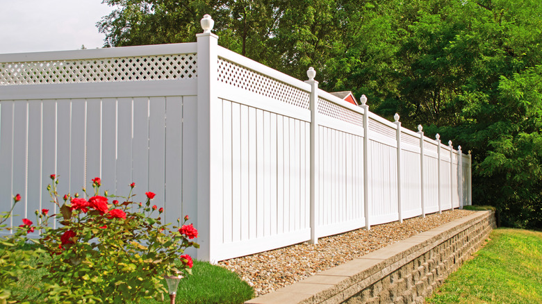 White vinyl fence extending into the distance