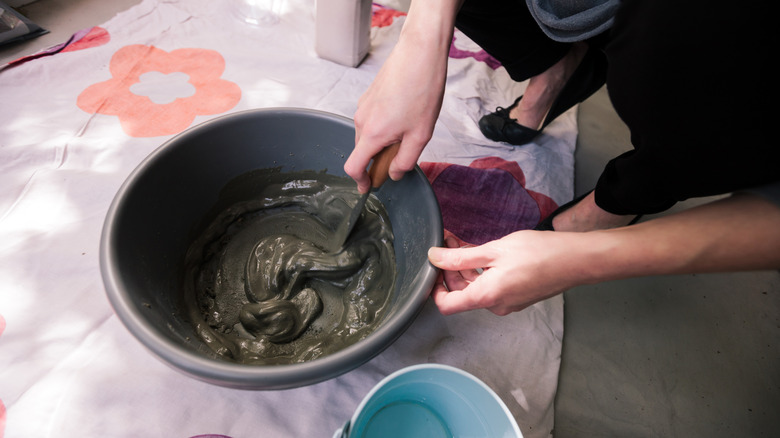 Someone mixing concrete for a craft