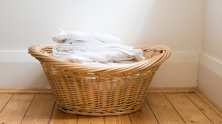 wicker basket of white laundry