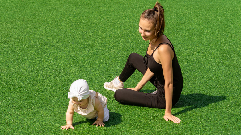 Baby playing on artificial lawn