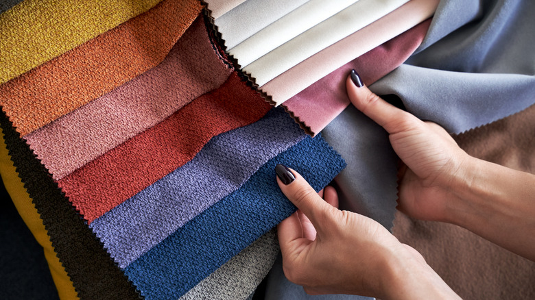 Hands picking out fabric