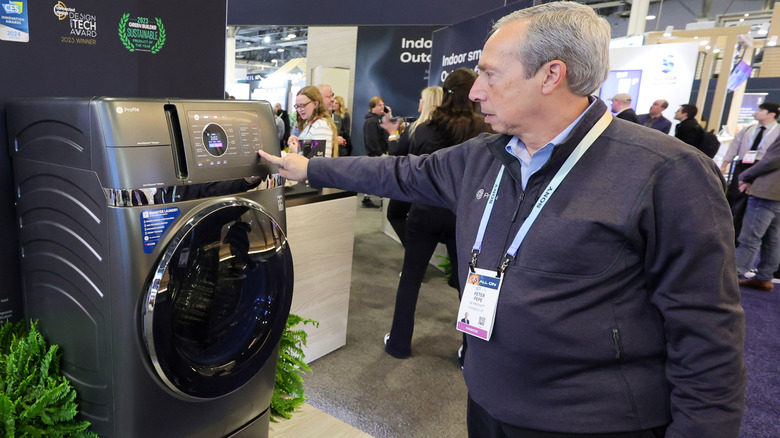Man testing a washer/dryer combo unit at CES