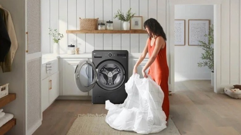 Woman loading a washer/dryer combo unit