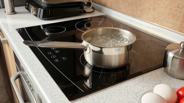 An induction cooktop with a pot of boiling water