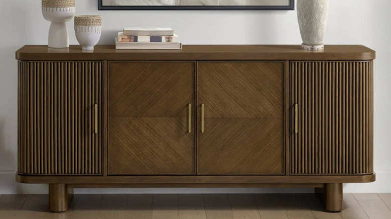 The Costco Montebello 68" accent console styled with vases, books, and a lamp