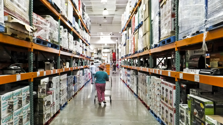 Shopper walking down Costco aisle