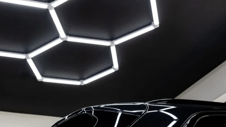 Hex lights installed on a black ceiling in a garage