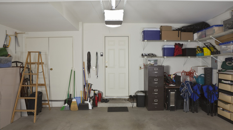 A garage with things stored along the walls