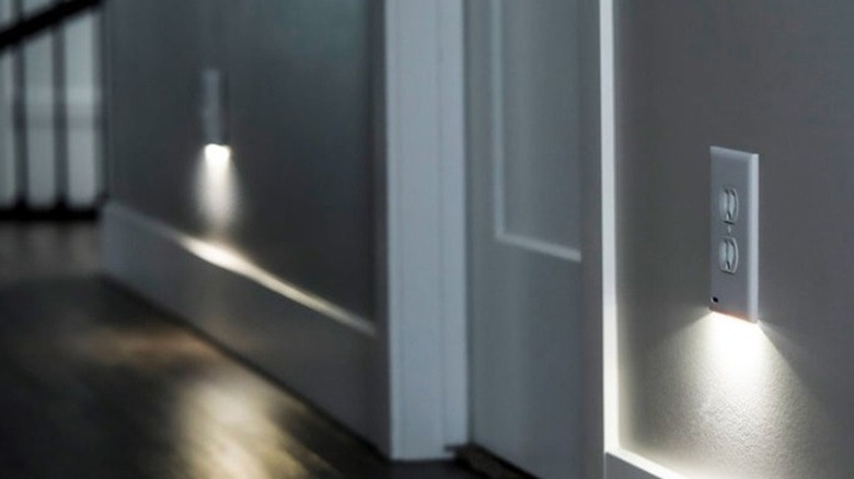 LED outlet covers in a darkened hallway