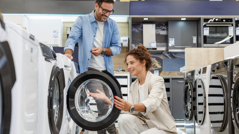 Couple examining washer in store