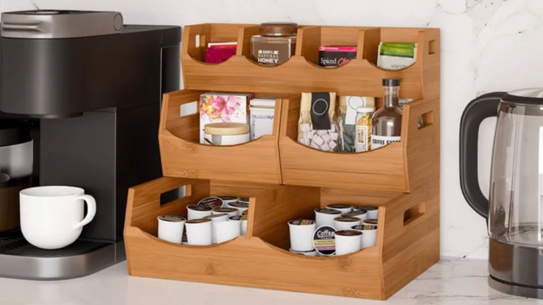 Stackable bin organizer on kitchen counter holding coffee and tea supplies.