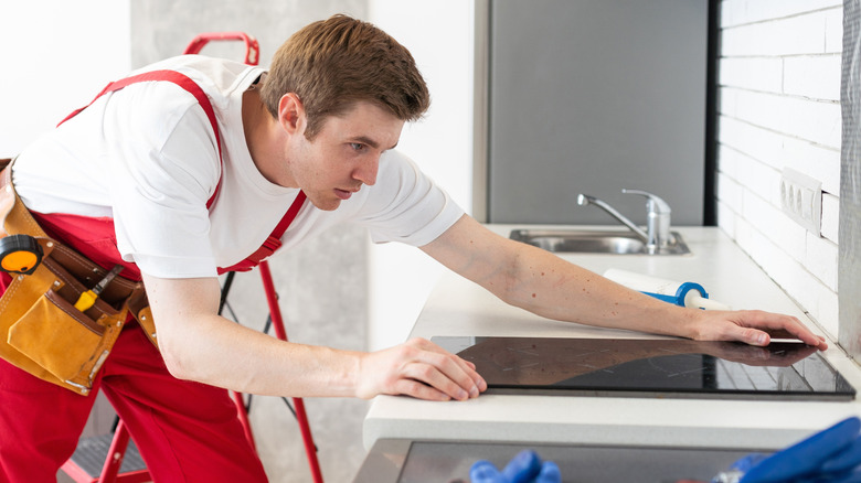 A man installing induction stove