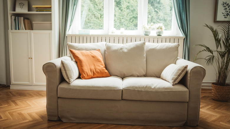 light neutral sofa in front of a window with gap in between