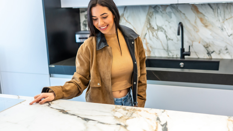 Woman smiling and looking at a countertop