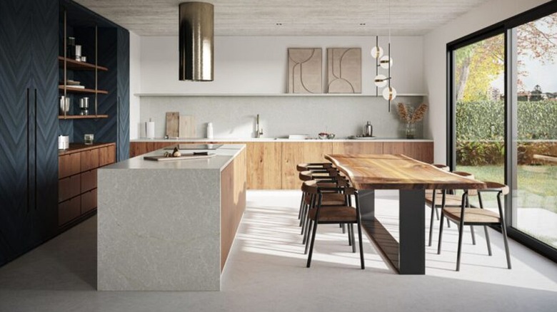 Modern kitchen with Caesarstone countertops and island, wood cabinets, and wood dining table