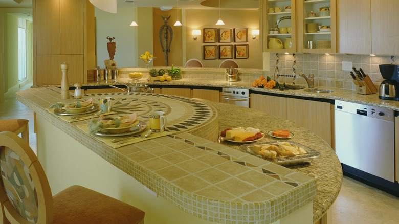 Dated kitchen with tile and granite countertops