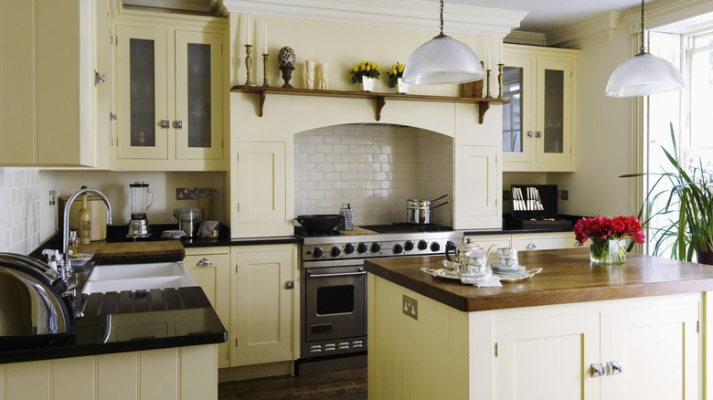 country kitchen with black countertops and butcher block island