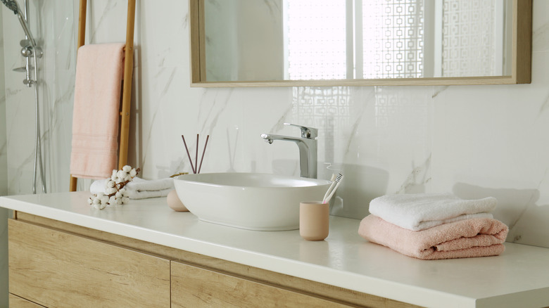 A white bathroom with light pink accents