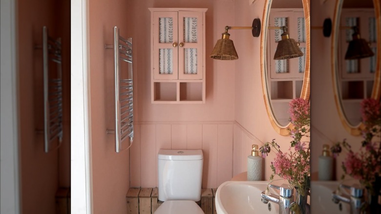 A bedroom painted soft pink with various contrasts and textures