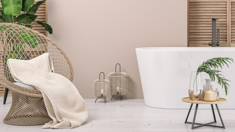 A soft pink hue bathroom with wood details